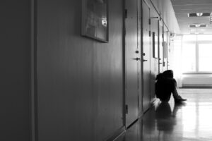 Young person sitting in hospital corridor